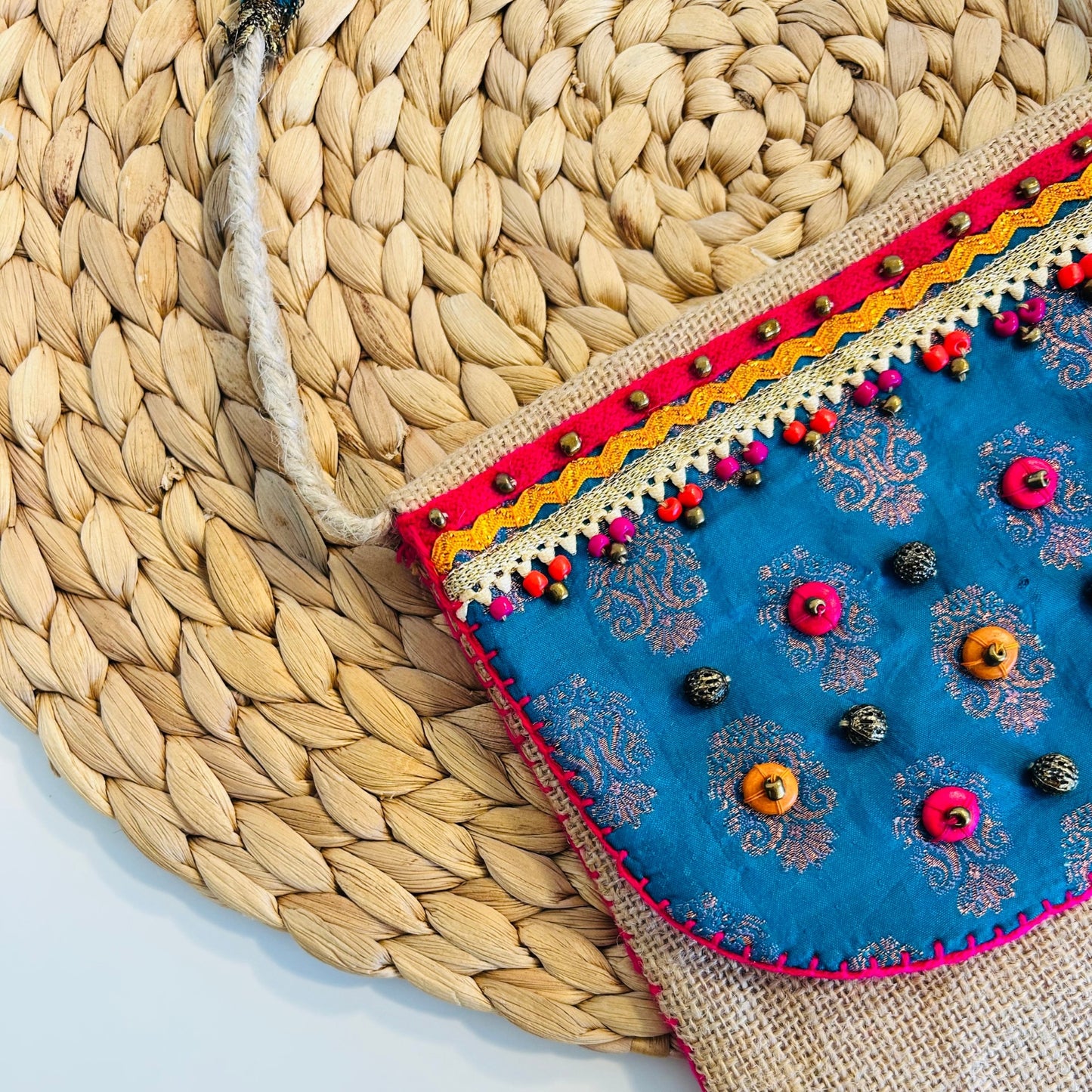 NATURAL JUTE CROSSBODY BAG WITH BLUE AND PINK ACCENTS